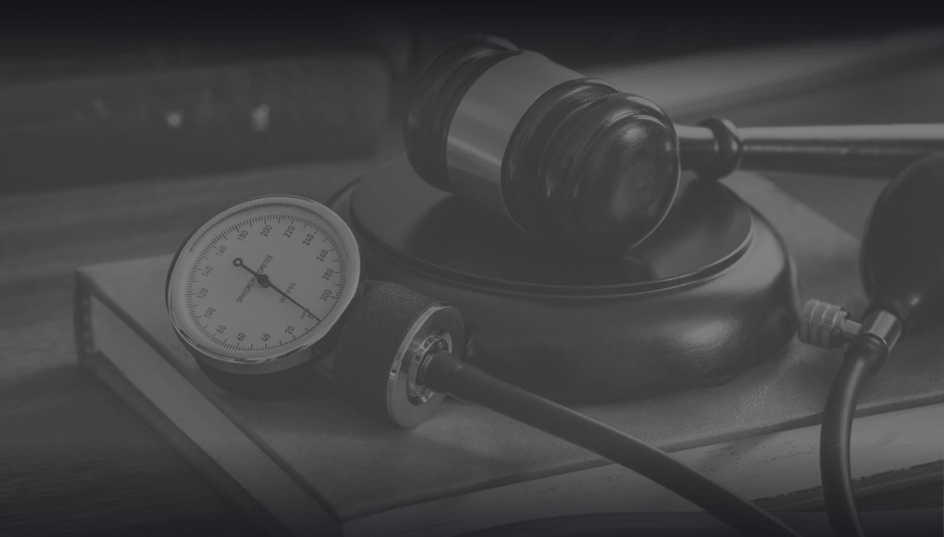 A stethoscope and a blood pressure monitor on top of a table.